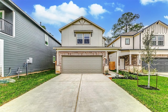 view of front facade with an attached garage, concrete driveway, and a front yard