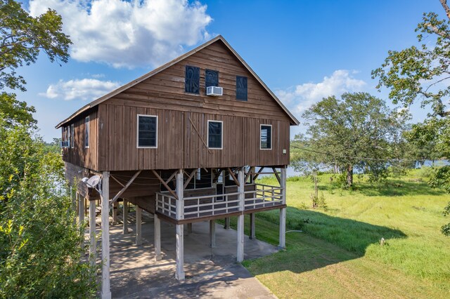 view of front of home with a front lawn and cooling unit