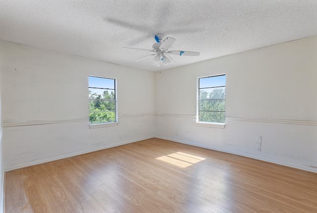 spare room with a textured ceiling, light hardwood / wood-style flooring, and ceiling fan