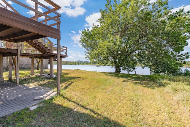 view of yard featuring a deck with water view