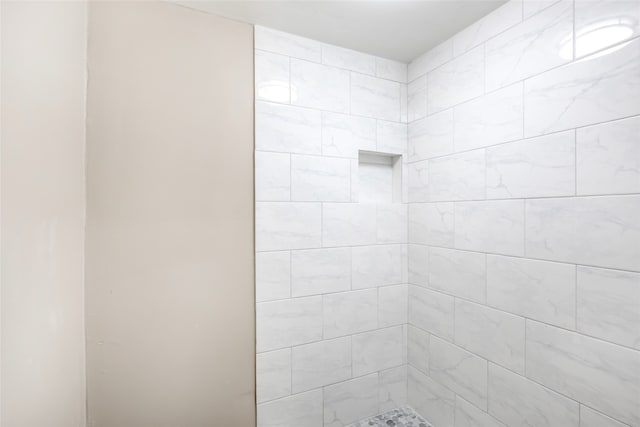 bathroom with tiled shower