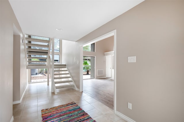 corridor featuring light tile patterned floors