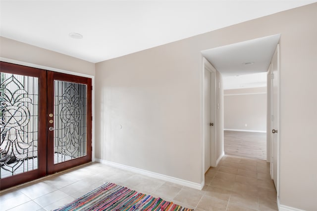 tiled entrance foyer featuring french doors