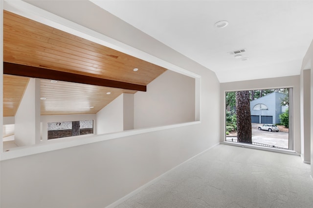 corridor with carpet flooring, vaulted ceiling with beams, and wooden ceiling