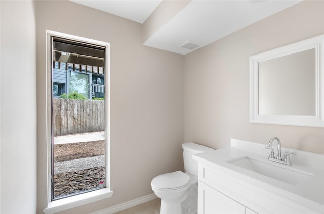 bathroom featuring vanity, toilet, and tile patterned floors