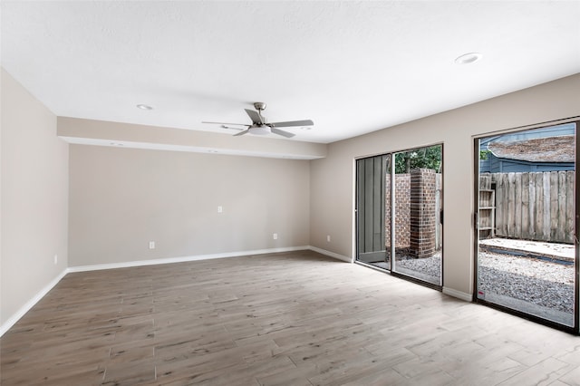 unfurnished room with ceiling fan and hardwood / wood-style flooring