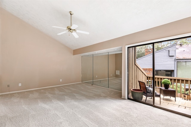 empty room with a textured ceiling, carpet, vaulted ceiling, and ceiling fan