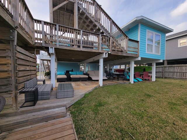 back of house featuring outdoor lounge area, a wooden deck, a yard, and a patio area