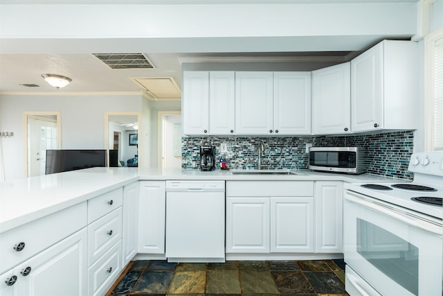 kitchen with white appliances, backsplash, ornamental molding, sink, and white cabinetry