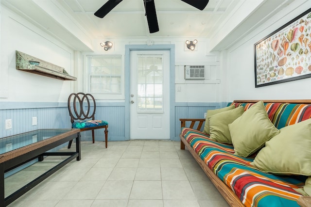 tiled living room featuring ceiling fan, crown molding, and a wall mounted air conditioner