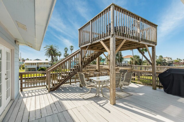 wooden deck featuring a water view and area for grilling