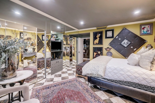 bedroom with a closet and crown molding