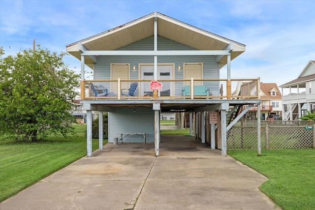 back of house featuring a lawn and a carport