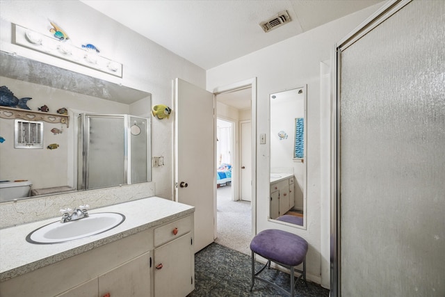 bathroom featuring walk in shower, toilet, and vanity