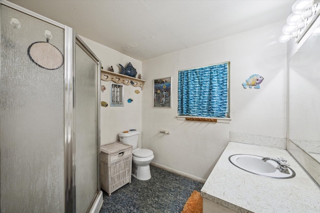 bathroom featuring vanity, toilet, and a shower with door