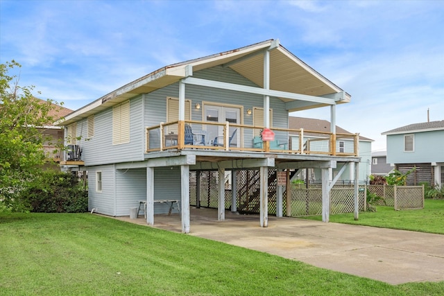 back of house featuring a lawn and a carport