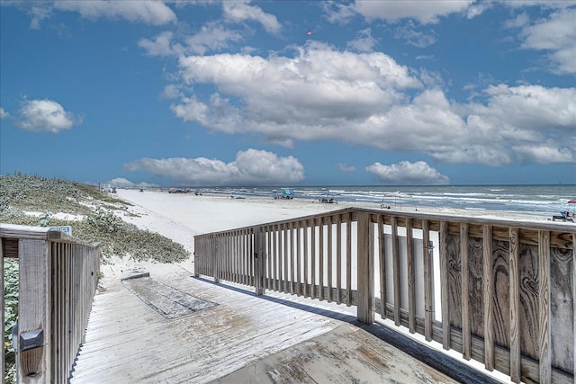 deck with a water view and a view of the beach