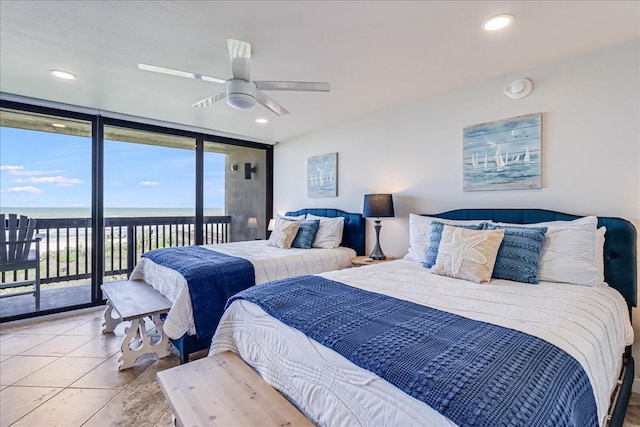 bedroom featuring access to exterior, ceiling fan, light tile patterned floors, and a water view