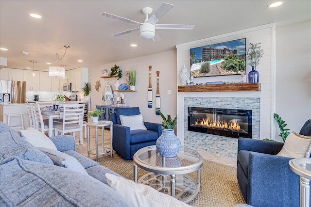 living room featuring a fireplace and ceiling fan