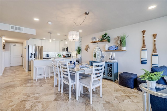 dining area featuring a notable chandelier