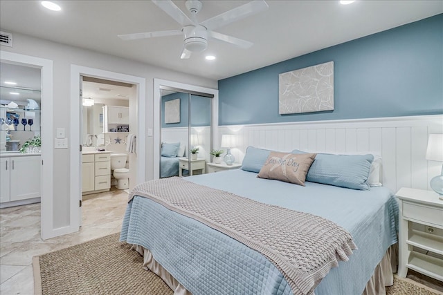 bedroom featuring ceiling fan and ensuite bath