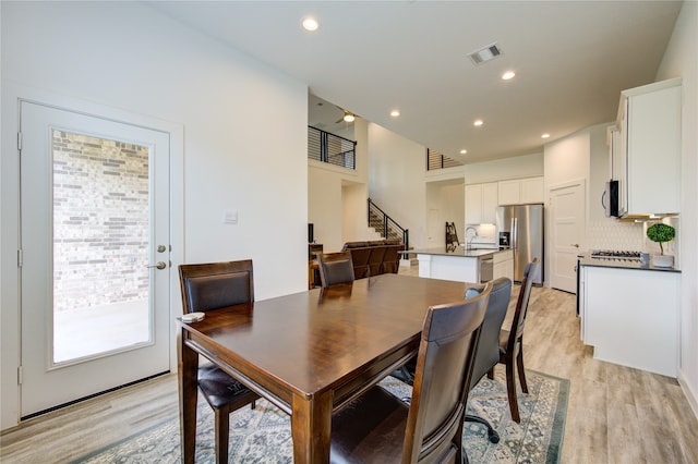 dining space featuring sink and light wood-type flooring