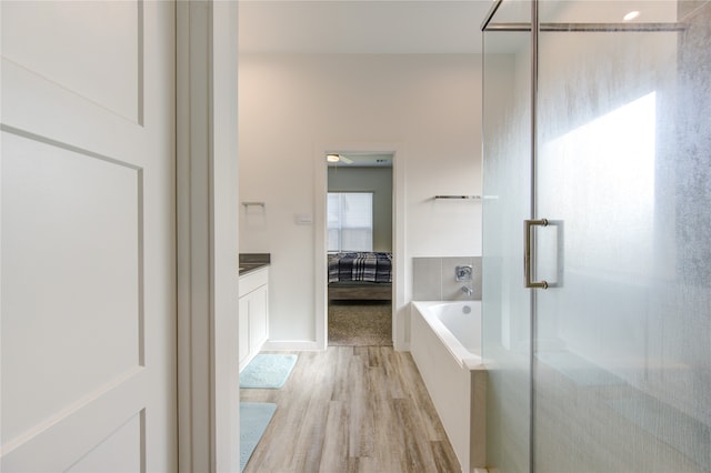 bathroom featuring vanity, hardwood / wood-style flooring, and independent shower and bath