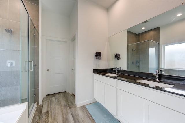 bathroom featuring vanity, hardwood / wood-style floors, and walk in shower