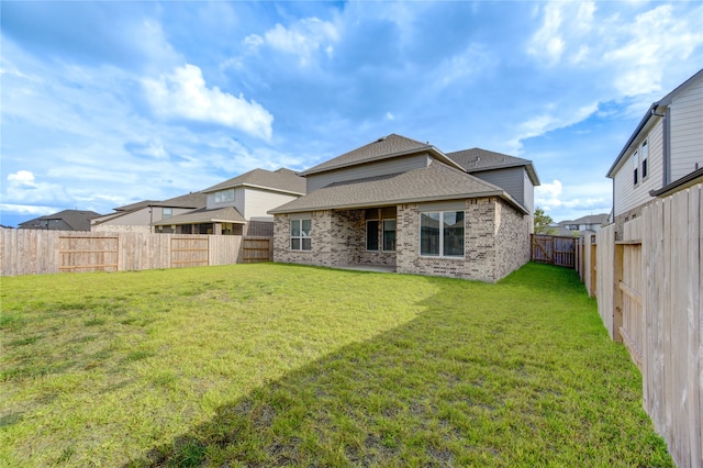 rear view of house featuring a yard