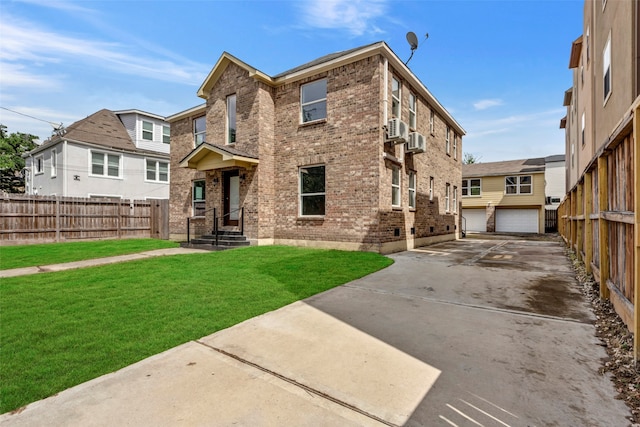 back of property featuring a yard, a garage, and an outdoor structure