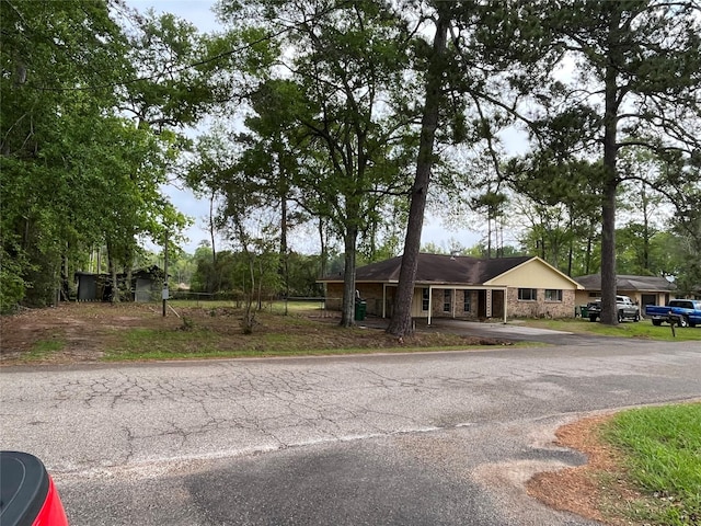 1801 Southline St, Cleveland, TX 77327 - view of front of house with asphalt driveway and stone siding
