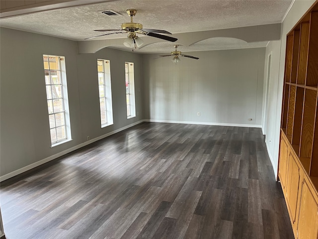 spare room with dark wood-type flooring, a textured ceiling, and ceiling fan