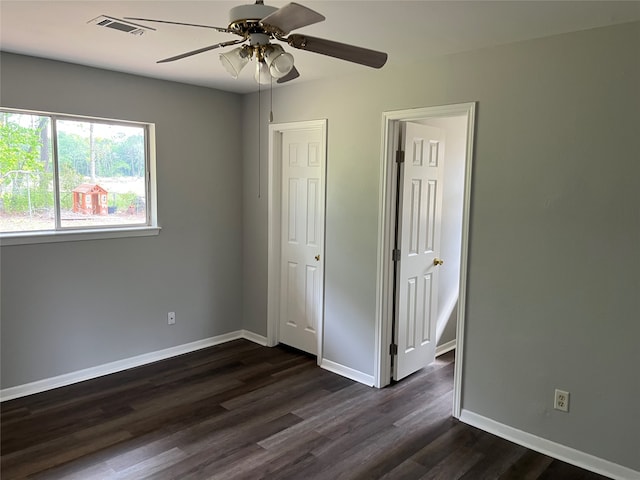 unfurnished bedroom with ceiling fan and dark hardwood / wood-style floors