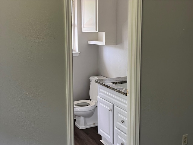 1801 Southline St, Cleveland, TX 77327 - bathroom featuring vanity, toilet, and wood finished floors