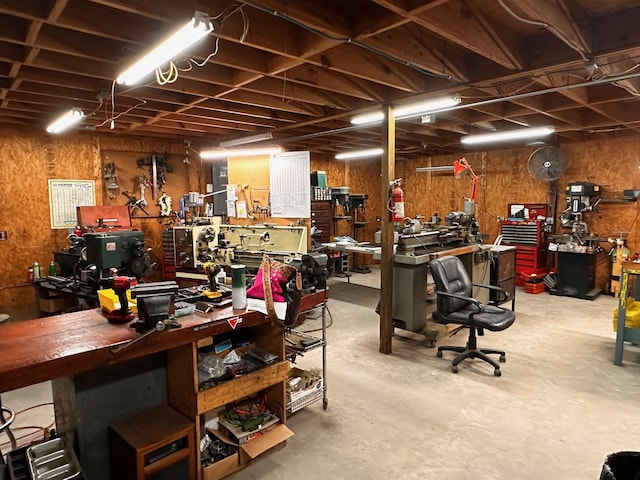 miscellaneous room featuring concrete flooring and a workshop area