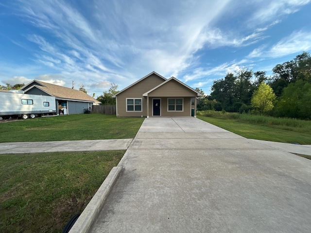 view of front of home with a front lawn and fence