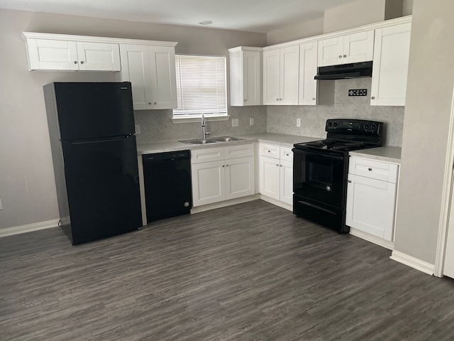 kitchen with dark hardwood / wood-style floors, black appliances, tasteful backsplash, sink, and white cabinetry