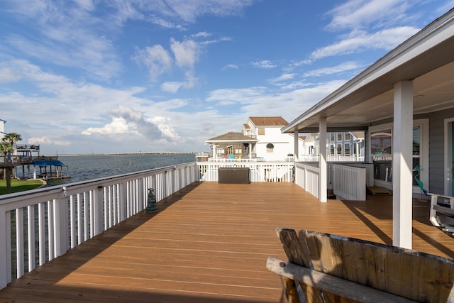 wooden terrace featuring a water view