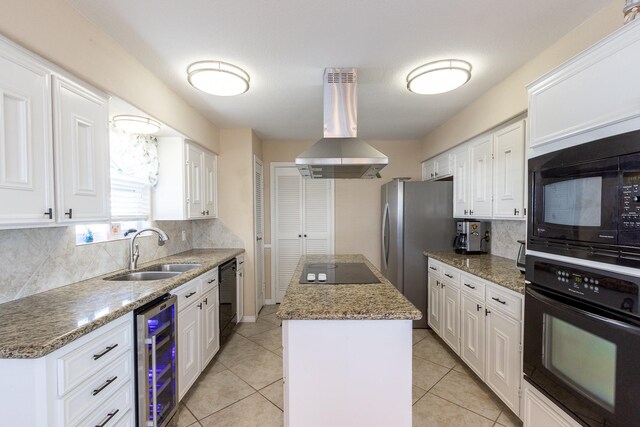 kitchen featuring wine cooler, a kitchen island, island exhaust hood, black appliances, and sink