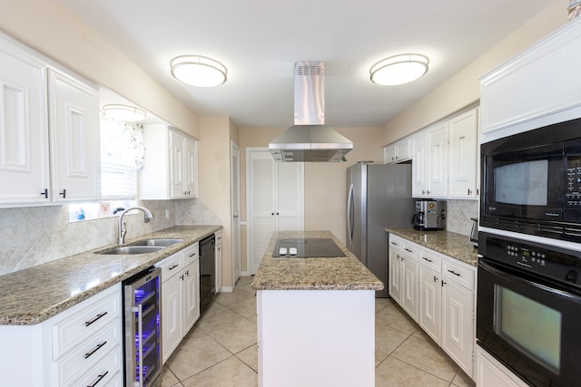 kitchen with a kitchen island, black appliances, beverage cooler, sink, and extractor fan