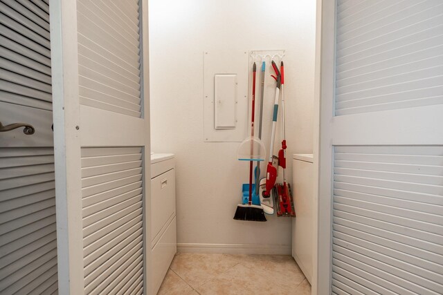 interior space with electric panel and light tile patterned floors