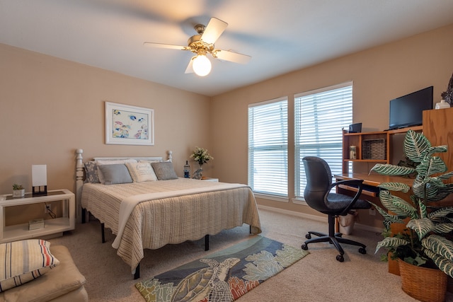 bedroom with ceiling fan and light carpet