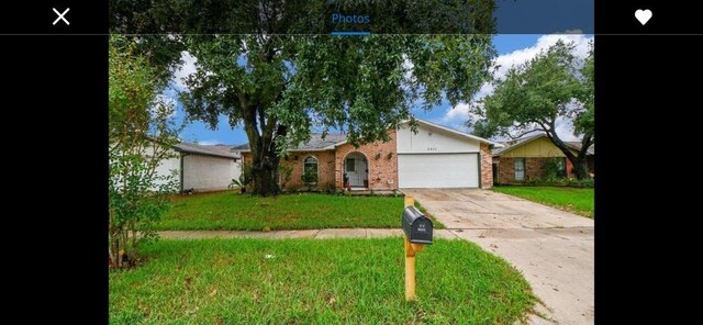 ranch-style house with a garage and a front yard