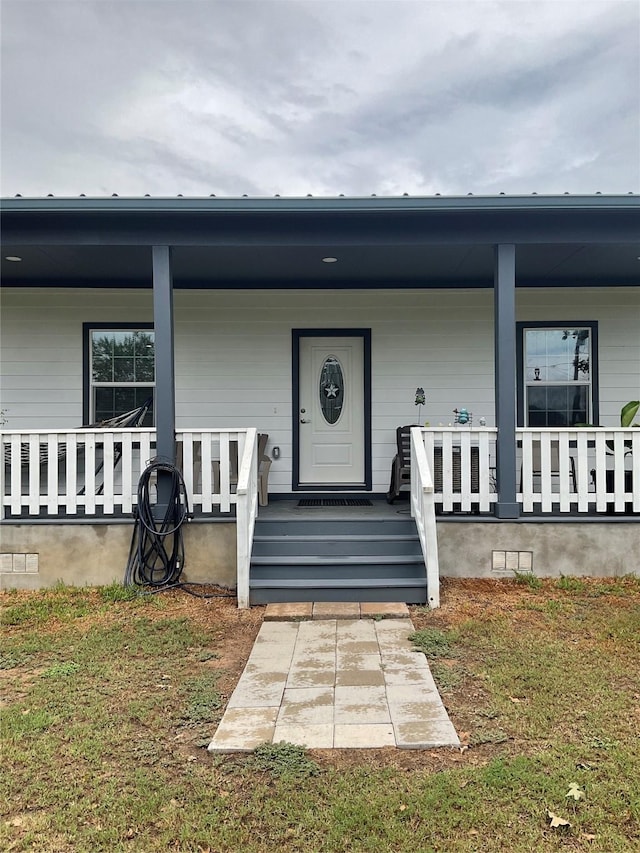 doorway to property with a porch