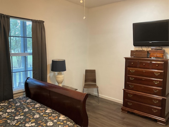 bedroom with dark wood-type flooring