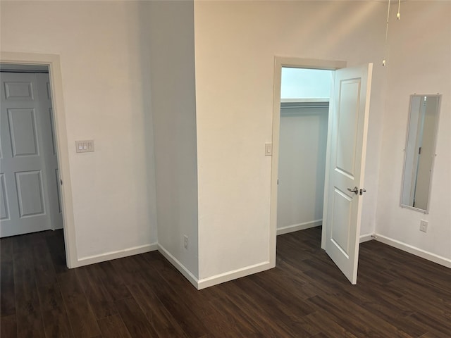 interior space with dark hardwood / wood-style flooring and a closet