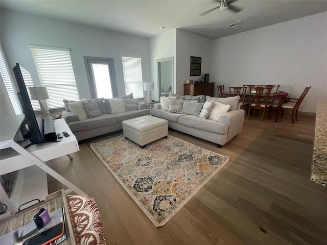 living area with ceiling fan and wood finished floors