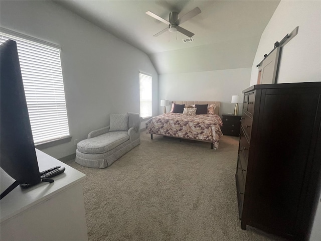 carpeted bedroom with a barn door, visible vents, ceiling fan, and lofted ceiling