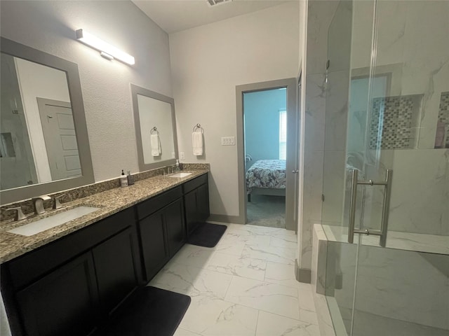 bathroom featuring a sink, a marble finish shower, marble finish floor, and double vanity