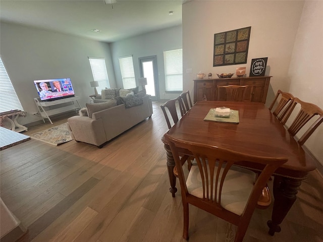 dining space featuring light wood-style floors